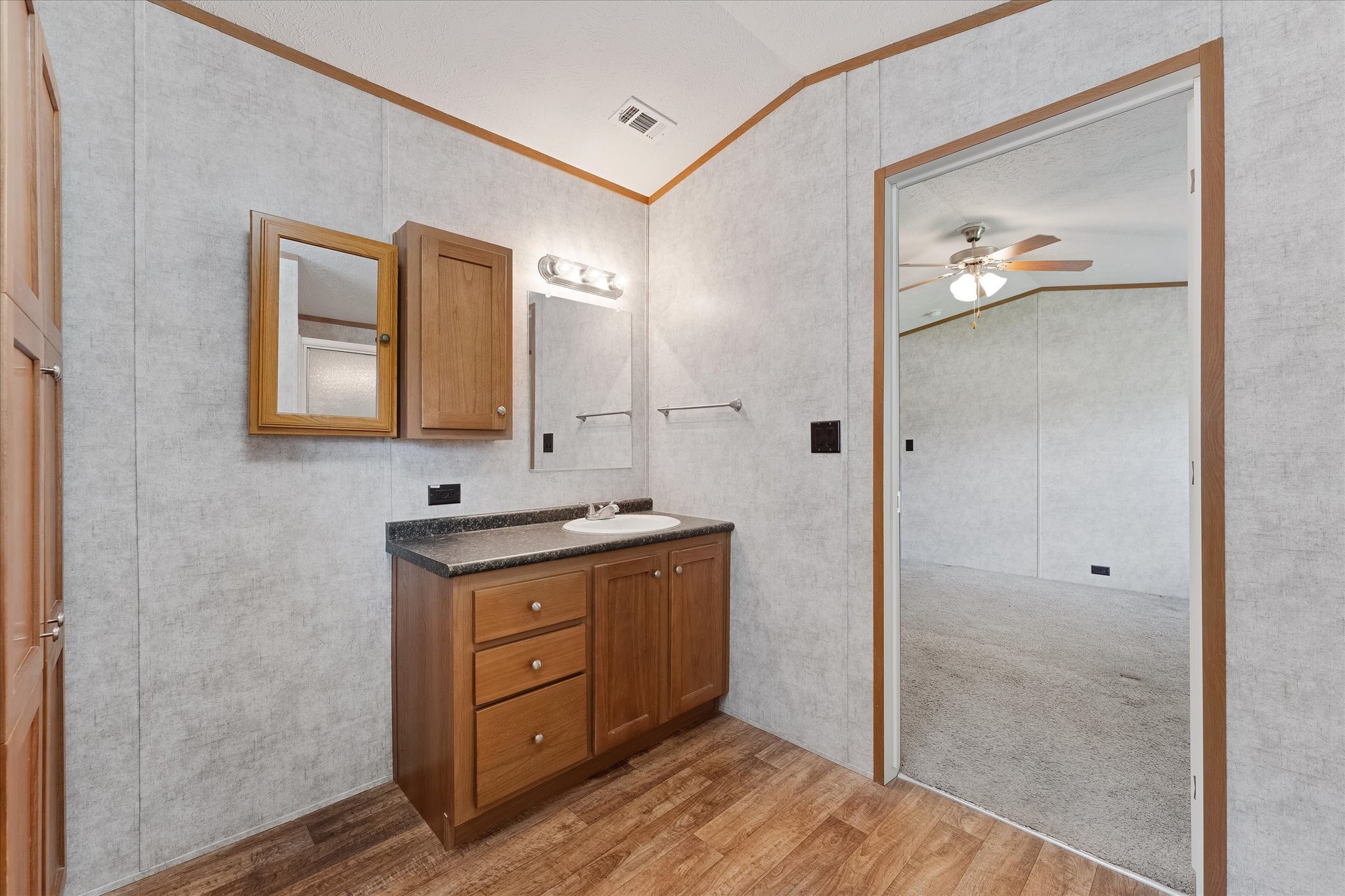 23419 Quiet Hollow Road Montgomery, TX 77356 - Photo 35 of 46 a bathroom with a granite countertop sink a mirror and a shower