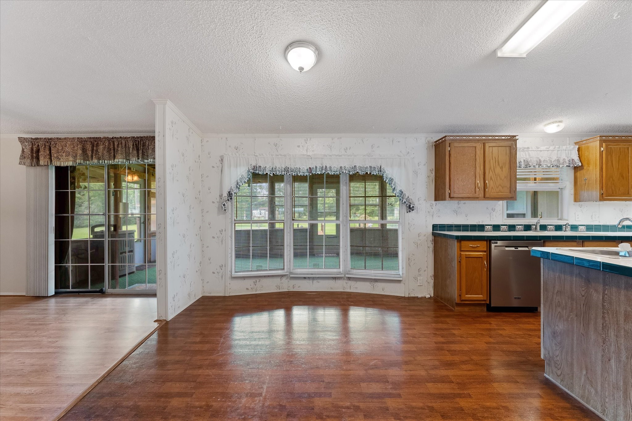 23419 Quiet Hollow Road Montgomery, TX 77356 - Photo 7 of 46 a view of a kitchen with granite countertop a large window and a sink