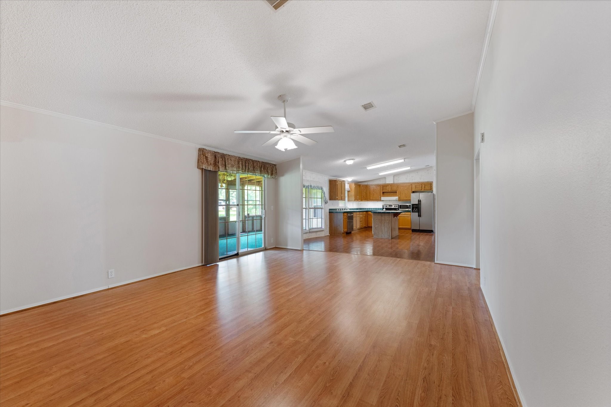 23419 Quiet Hollow Road Montgomery, TX 77356 - Photo 9 of 46 a view of an empty room with wooden floor and a window