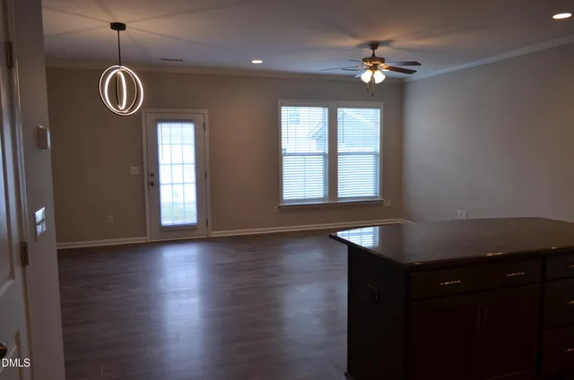 a view of a livingroom with furniture wooden floor and a window