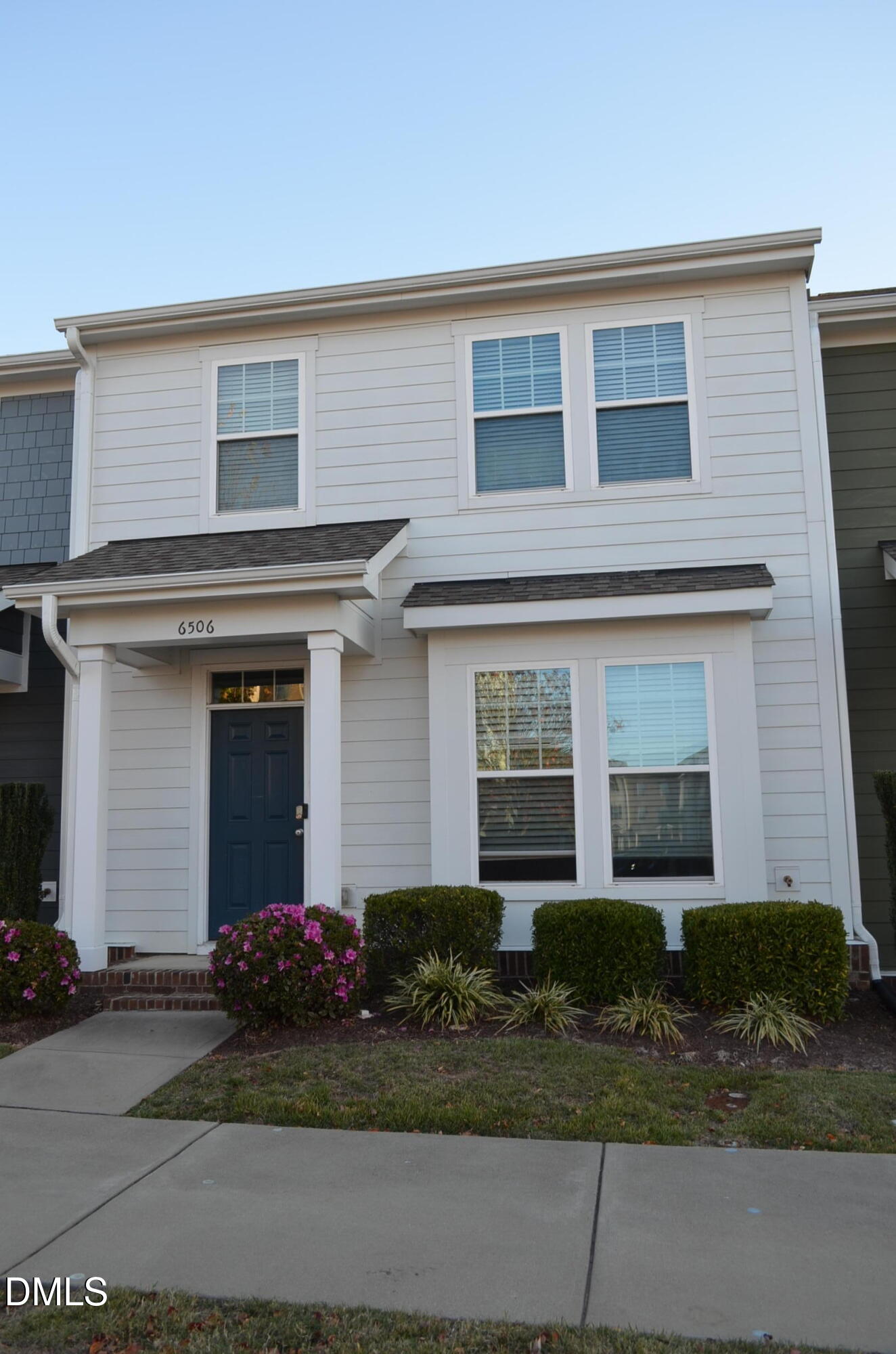 6506 Perry Creek Road, Unit 1103 Raleigh, NC 27616 - Photo 2 of 34 a front view of a house with garage and plants