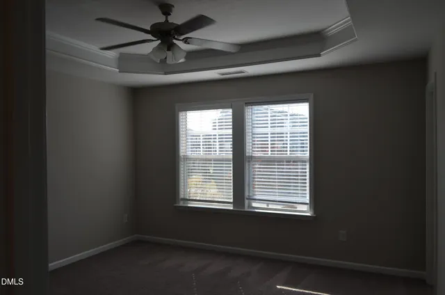 a room with a window and a ceiling fan