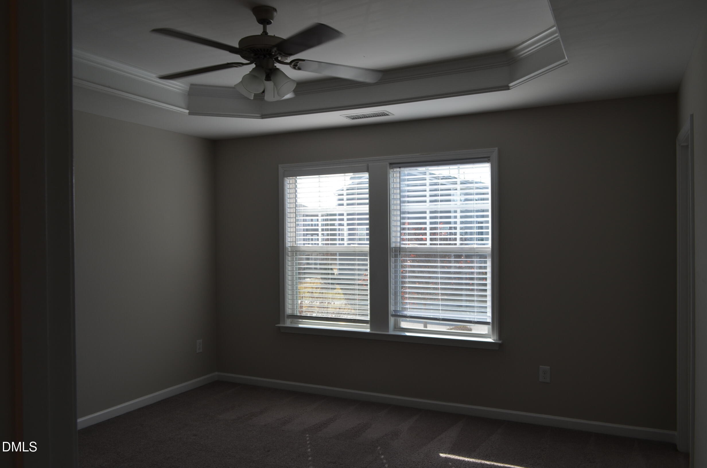 6506 Perry Creek Road, Unit 1103 Raleigh, NC 27616 - Photo 24 of 34 a room with a window and a ceiling fan