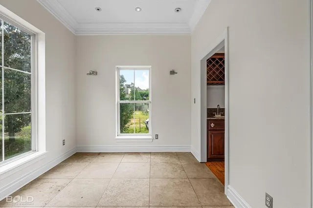 an empty room with windows and closet