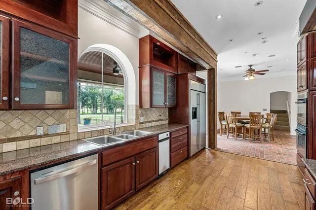 a kitchen with stainless steel appliances granite countertop a stove and a sink