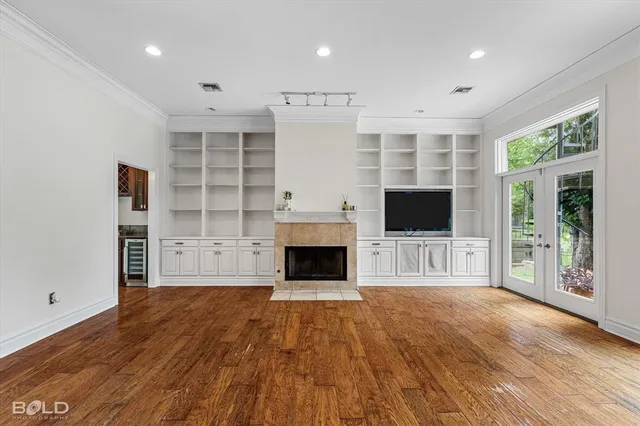 a view of a livingroom with a fireplace and window