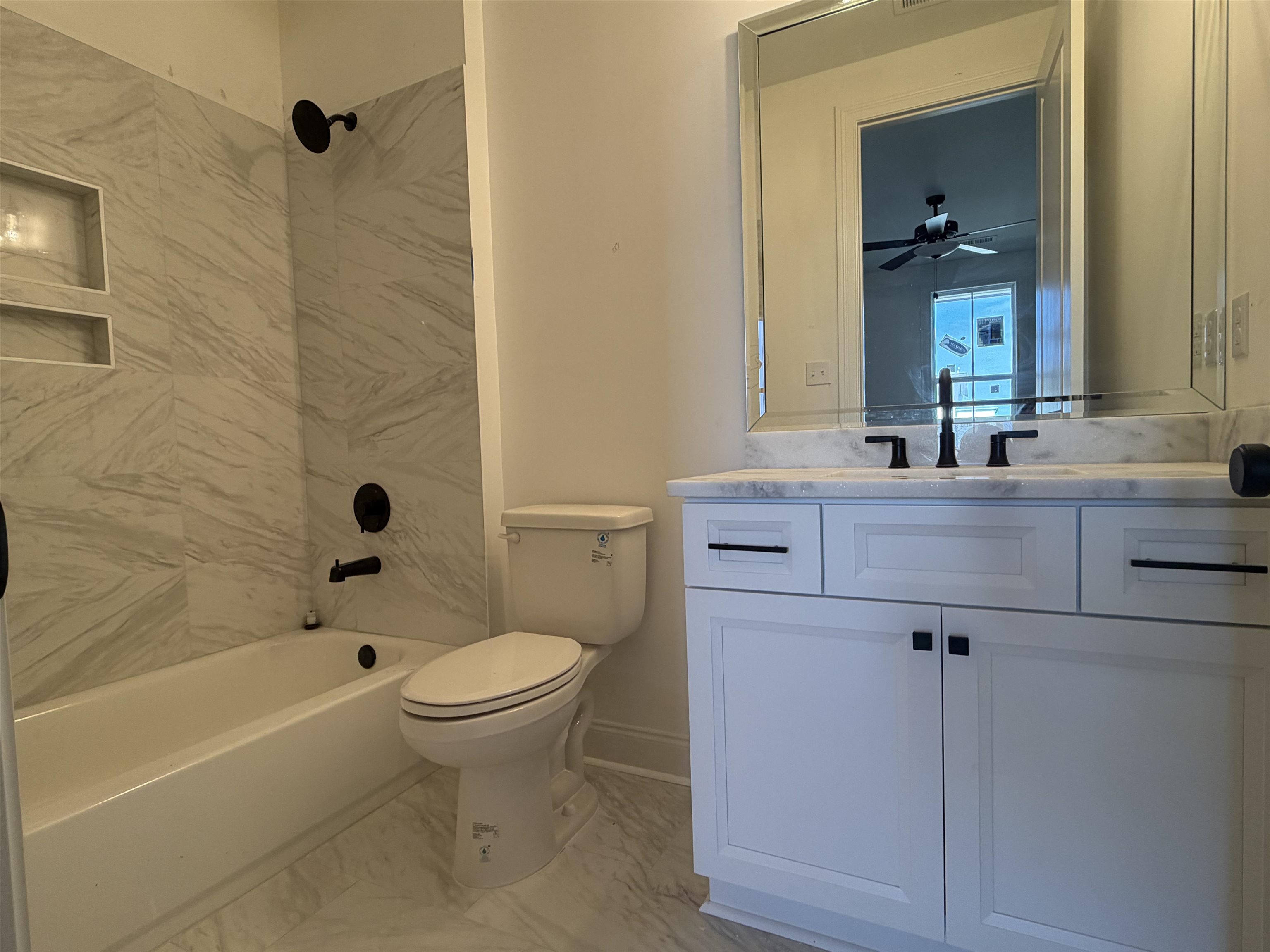 190 Rambling Rex Trail Piperton, TN 38017 - Photo 26 of 32 a bathroom with a bathtub a sink a toilet and a mirror