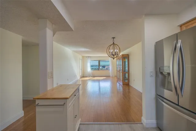 a view of a refrigerator in kitchen and wooden floor