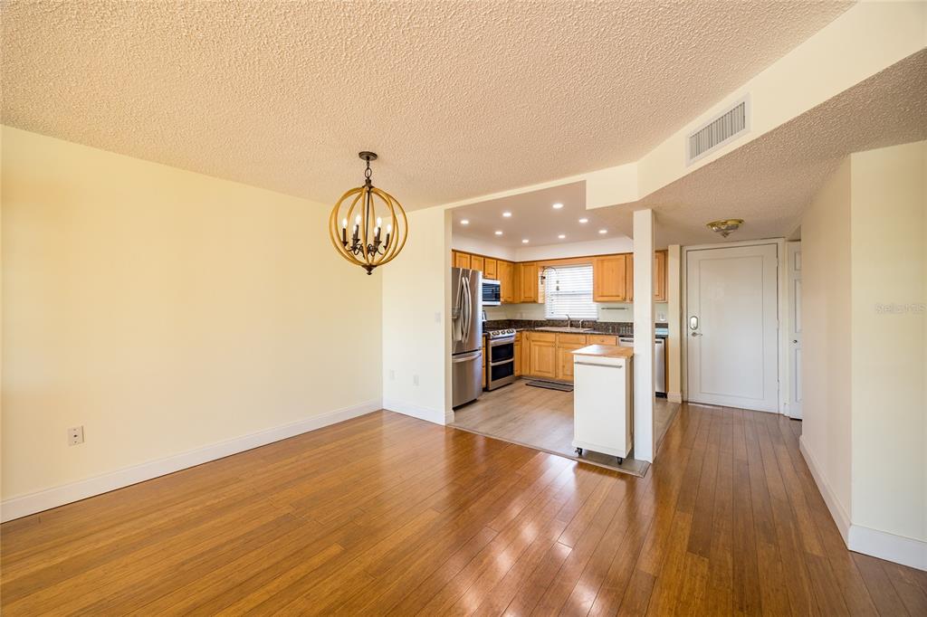 4775 Cove Circle, Unit 1002 Madeira Beach, FL 33708 - Photo 13 of 60 a view of a room with wooden floor
