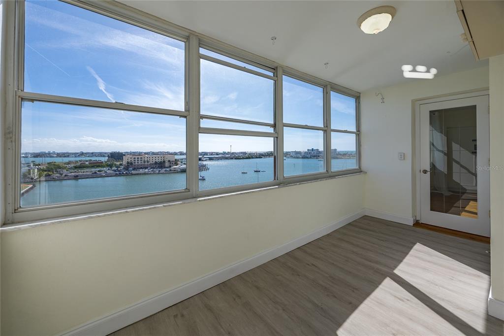 4775 Cove Circle, Unit 1002 Madeira Beach, FL 33708 - Photo 20 of 60 an empty room with wooden floor and windows