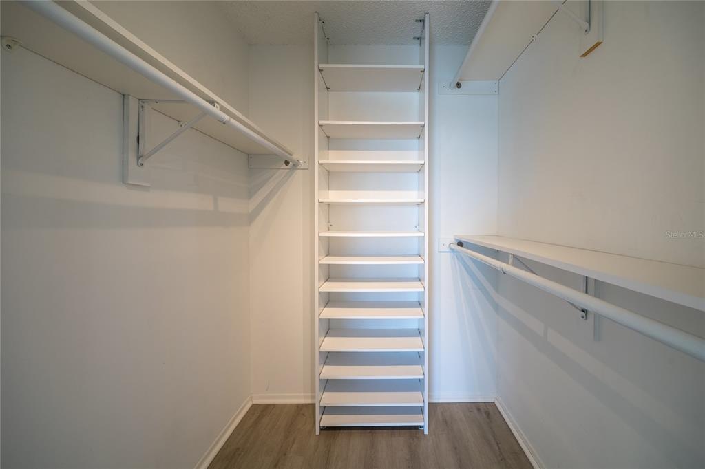 4775 Cove Circle, Unit 1002 Madeira Beach, FL 33708 - Photo 23 of 60 a view of walk in closet with empty racks