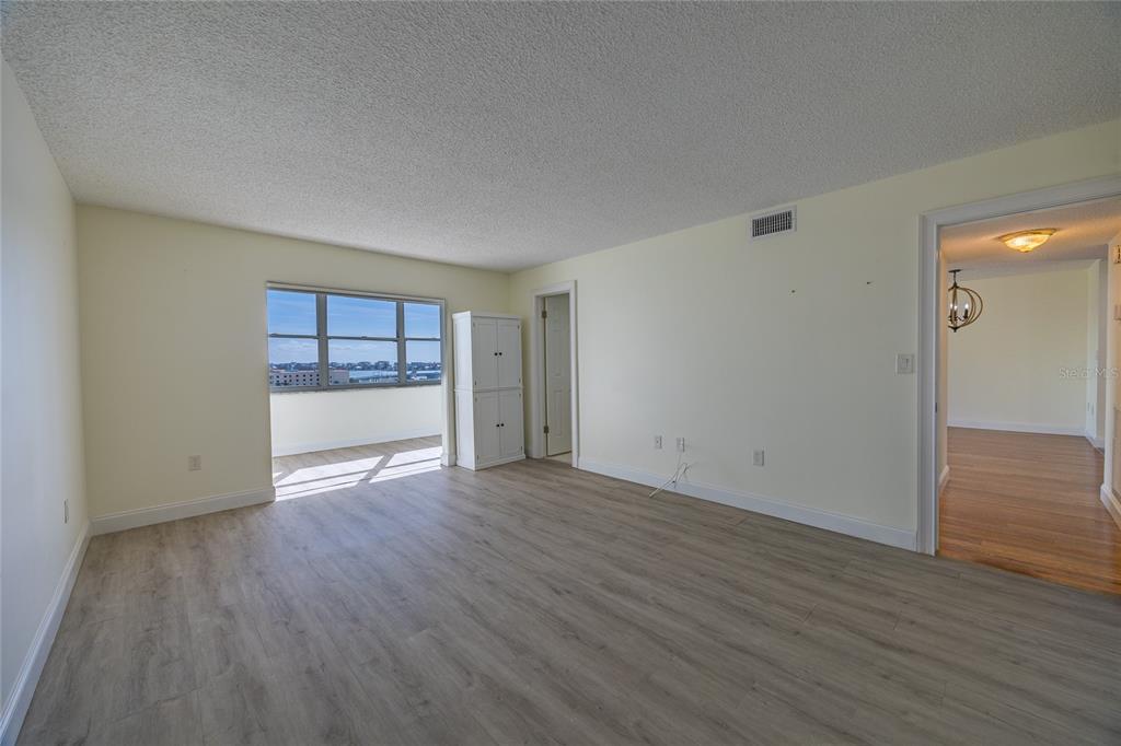 4775 Cove Circle, Unit 1002 Madeira Beach, FL 33708 - Photo 24 of 60 wooden floor in an empty room with a window