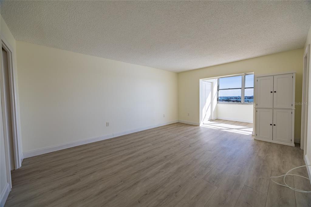 4775 Cove Circle, Unit 1002 Madeira Beach, FL 33708 - Photo 25 of 60 wooden floor in an empty room with a window