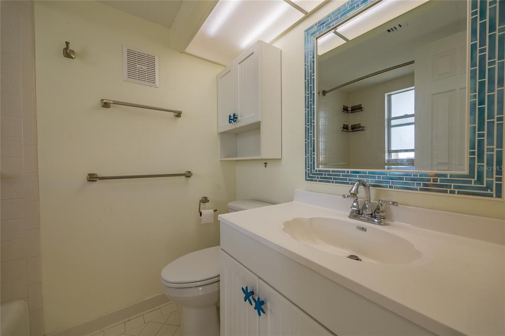 4775 Cove Circle, Unit 1002 Madeira Beach, FL 33708 - Photo 26 of 60 a bathroom with a sink toilet and shower