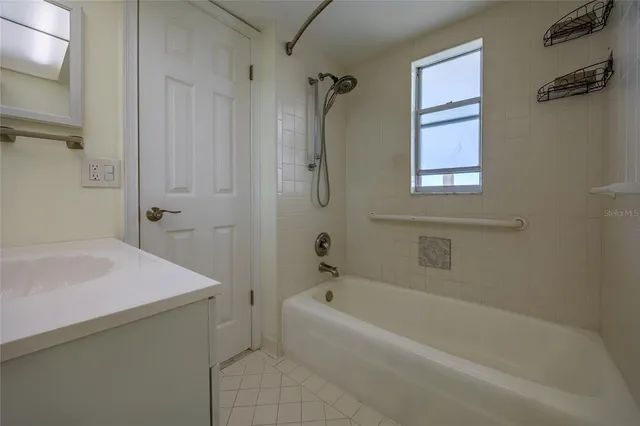 a bath room with a bath tub and a shower