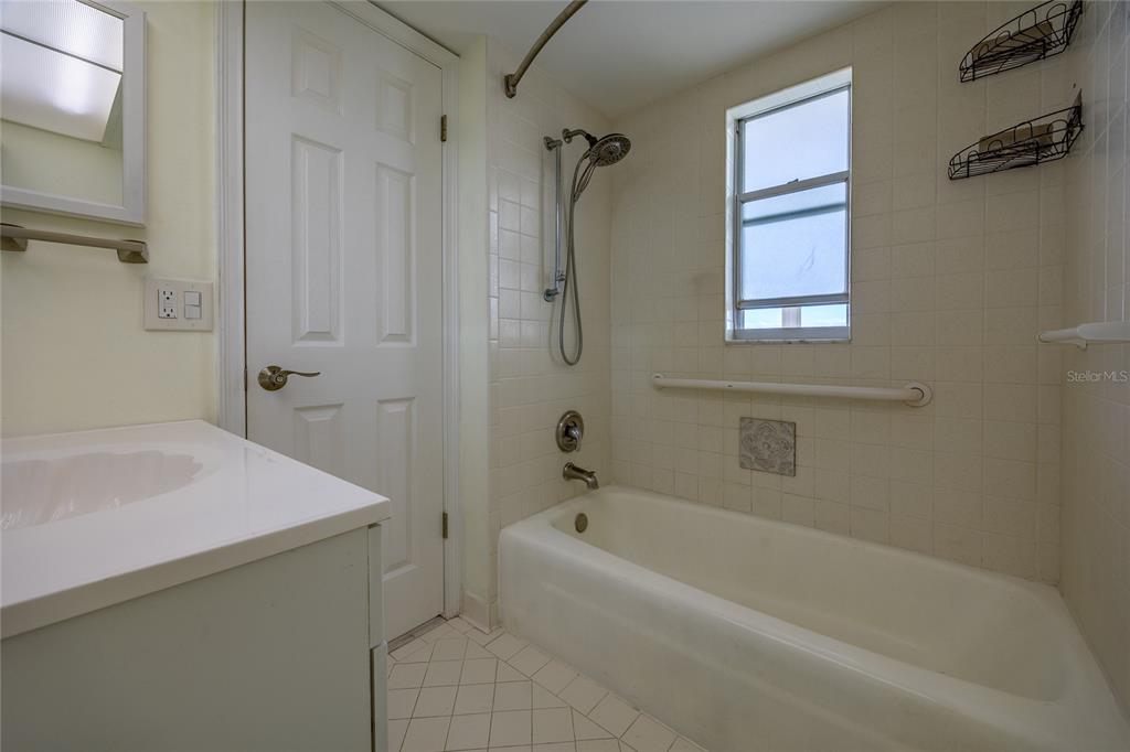 4775 Cove Circle, Unit 1002 Madeira Beach, FL 33708 - Photo 27 of 60 a bath room with a bath tub and a shower