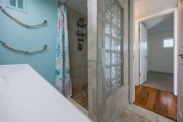 a bathroom with a glass shower door