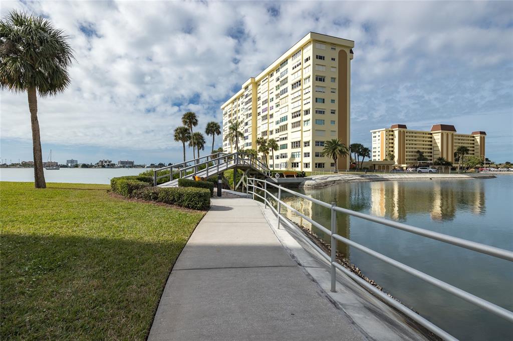 4775 Cove Circle, Unit 1002 Madeira Beach, FL 33708 - Photo 3 of 60 a view of a swimming pool with a lake