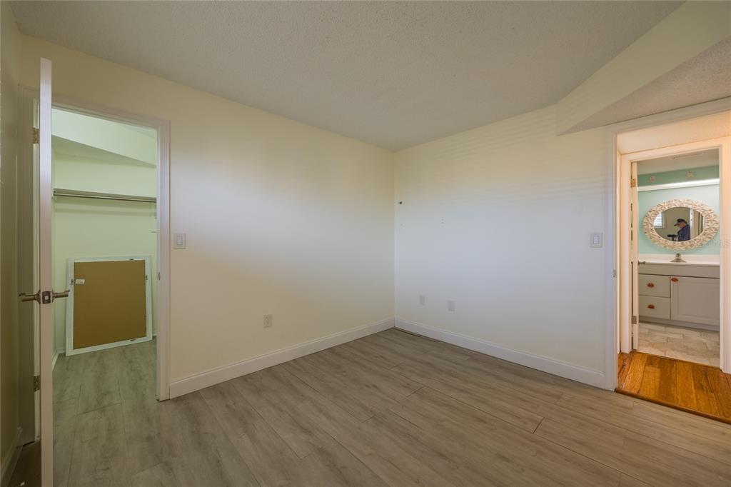 4775 Cove Circle, Unit 1002 Madeira Beach, FL 33708 - Photo 32 of 60 wooden floor in an empty room