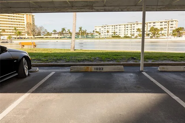 a front view of a building with a garden and plants