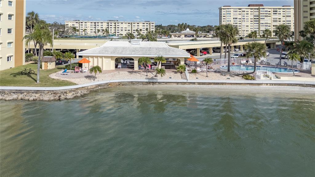 4775 Cove Circle, Unit 1002 Madeira Beach, FL 33708 - Photo 54 of 60 a view of a water fountain and a big yard