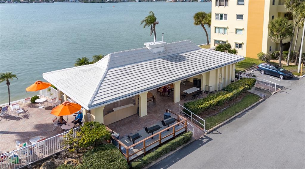 4775 Cove Circle, Unit 1002 Madeira Beach, FL 33708 - Photo 57 of 60 an aerial view of a house with pool and chairs