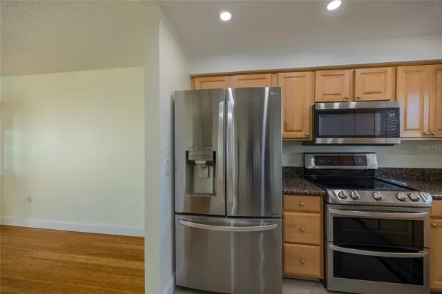 a kitchen with a refrigerator stove and microwave