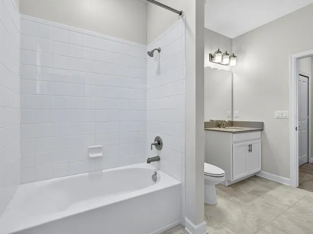 an empty room with closet and windows