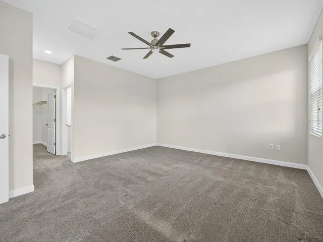 a view of a livingroom with a ceiling fan and window