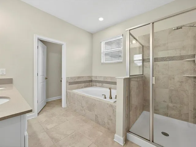 a bathroom with a double vanity sink and mirror