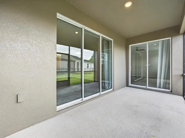 a view of a field with a tree in front of it