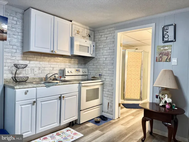 a kitchen with a sink cabinets and a window