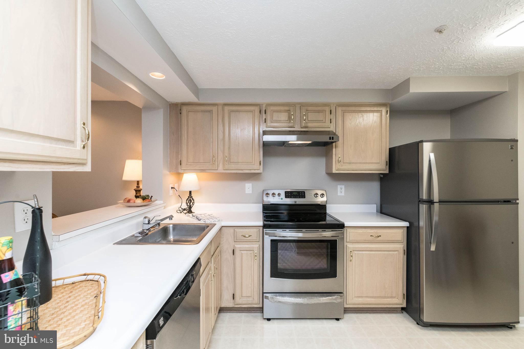4132 Maple Path Circle, Unit 61 Baltimore, MD 21236 - Photo 17 of 47 a kitchen with a stove a refrigerator and a sink