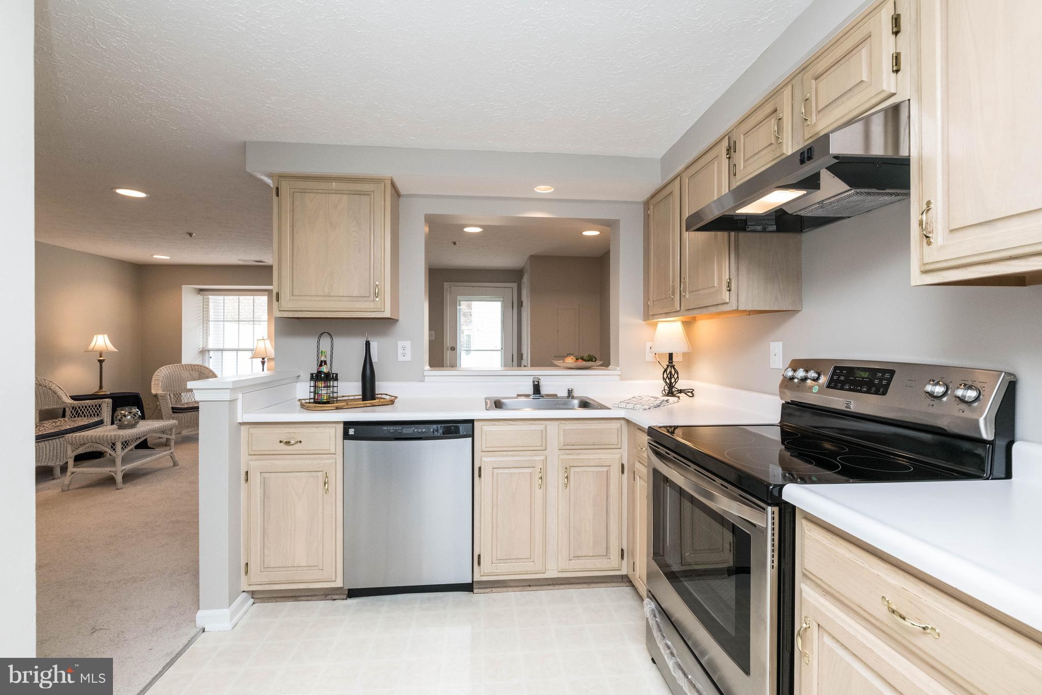 4132 Maple Path Circle, Unit 61 Baltimore, MD 21236 - Photo 20 of 47 a kitchen with a sink a stove and cabinets