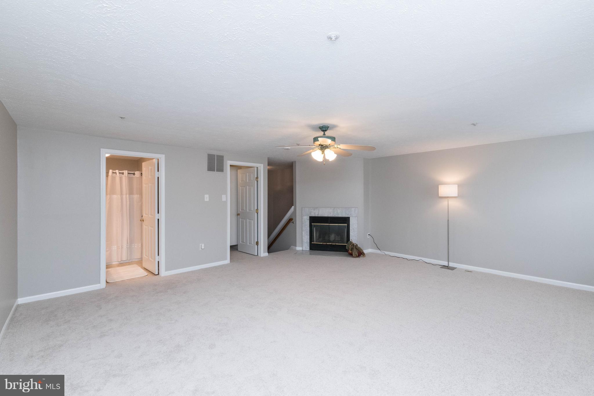 4132 Maple Path Circle, Unit 61 Baltimore, MD 21236 - Photo 38 of 47 an empty room with fireplace and windows