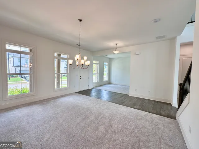 a view of a room with window and chandelier