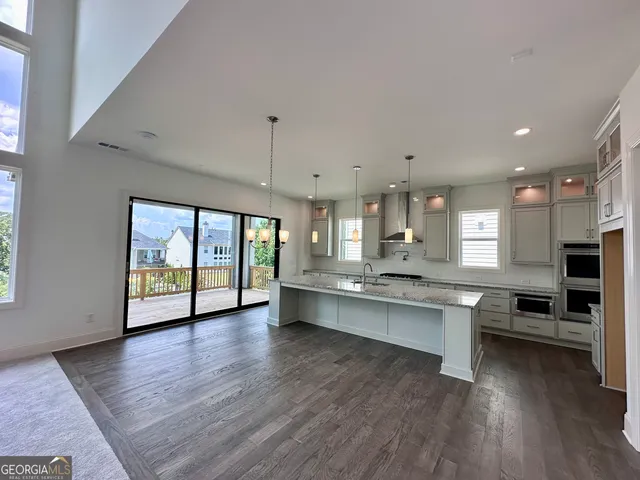 a large kitchen with lots of counter space a sink appliances and dining table