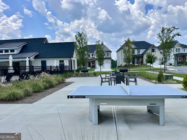 a view of a patio with table and chairs under an umbrella