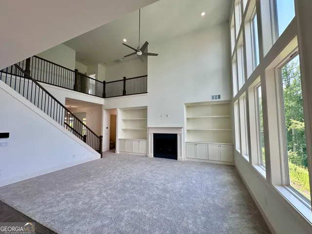 a view of a livingroom with an empty space and a fireplace