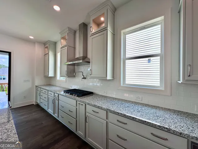 a kitchen with granite countertop a sink and cabinets