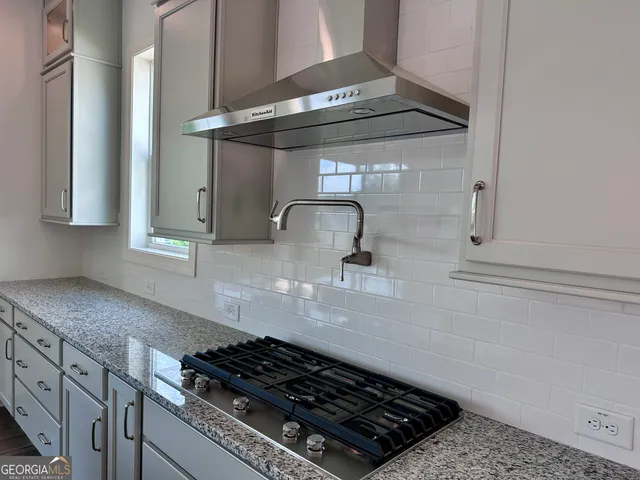 a close view of a stove a microwave and cabinets in the kitchen