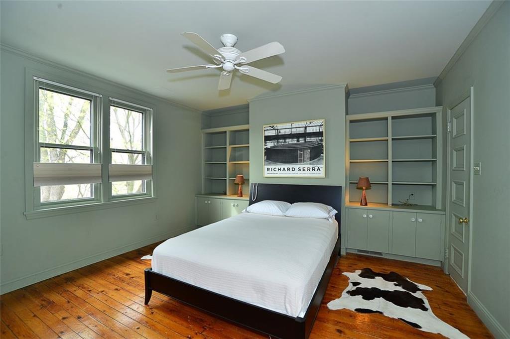 304 Bower Hill Road Pittsburgh, PA 15228 - Photo 12 of 25 Master bedroom with built in shelving/storage, paddle fan and beautiful hardwood floors. This room connects with the full bath on the second floor.