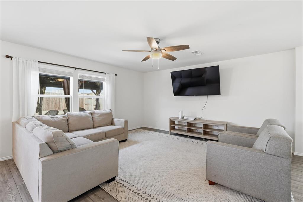 16041 Pious Drive Haslet, TX 76052 - Photo 10 of 36 Living area featuring wood finished floors and ceiling fan