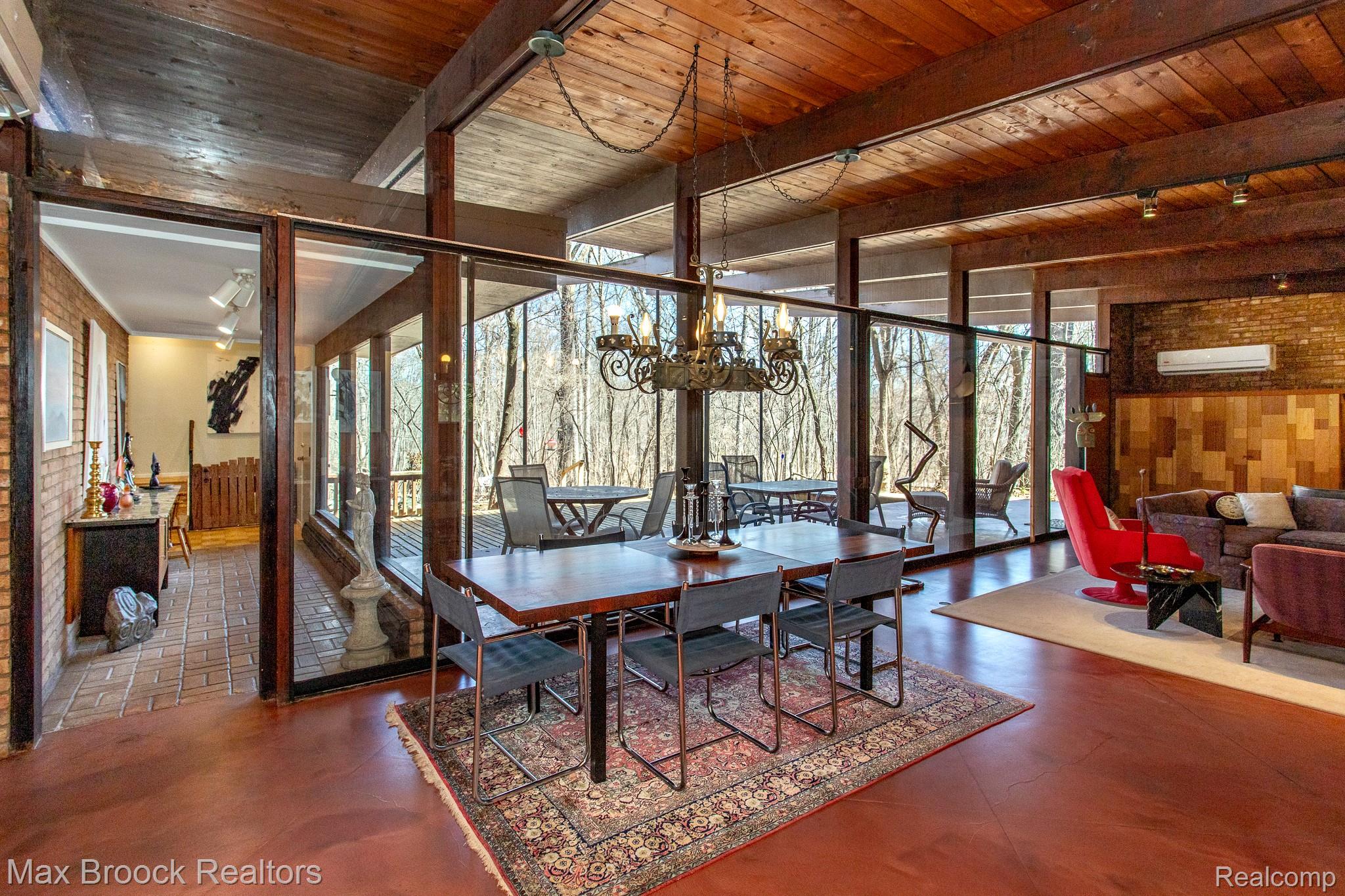 30875 Franklin Road Franklin, MI 48025 - Photo 45 of 86 Dining area with hanging lights, wooden walls, a wooden ceiling with exposed beams, and brick wall