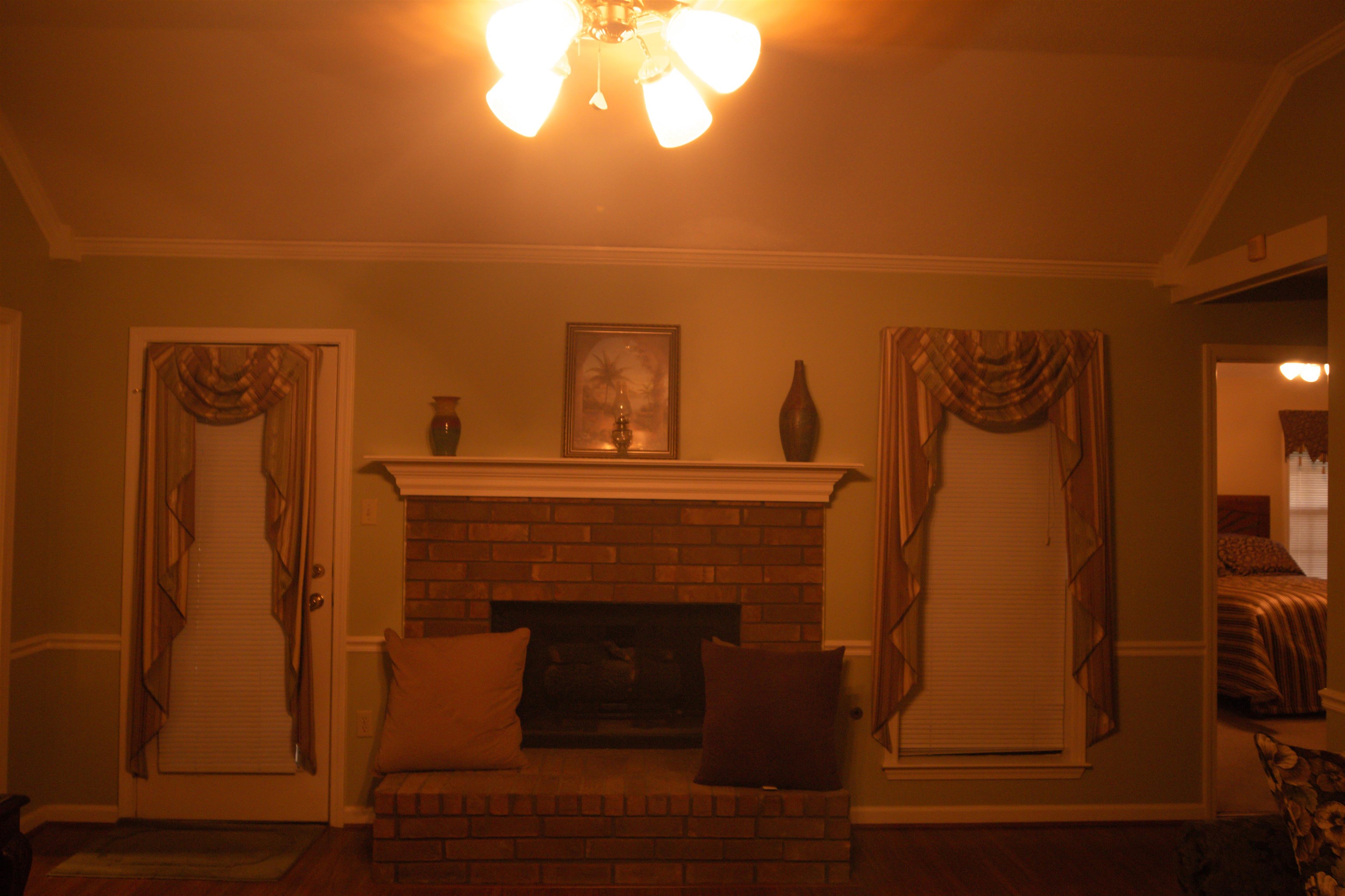 4100 Altruria Road Bartlett, TN 38135 - Photo 4 of 23 Living room featuring a fireplace, ceiling fan, dark hardwood / wood-style flooring, crown molding, and vaulted ceiling
