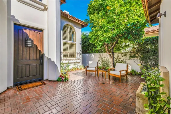 a view of a house with backyard and sitting area