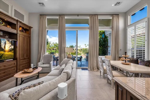 a bedroom with a bed a couch and a window