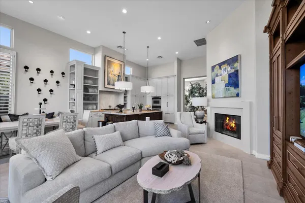 a bedroom with a bed a large window and flat screen tv