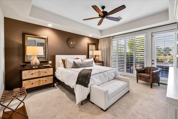 a bedroom with a bed and a flat tv screen on the dresser