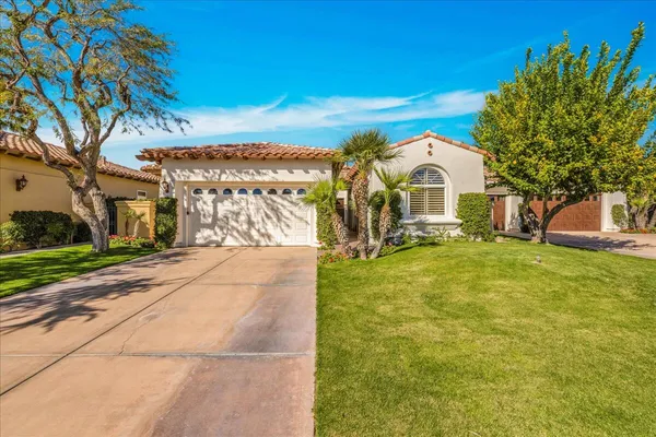 a view of a house with a yard and tree s